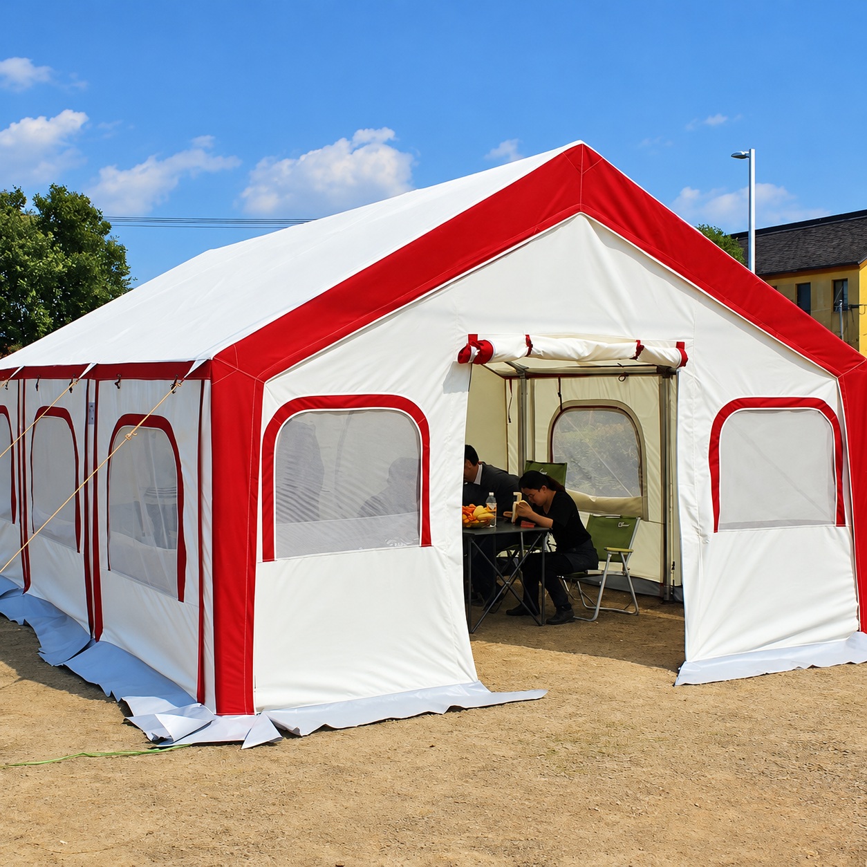 White and red ridge tent with a central front door, side windows, ground skirt and guy lines.