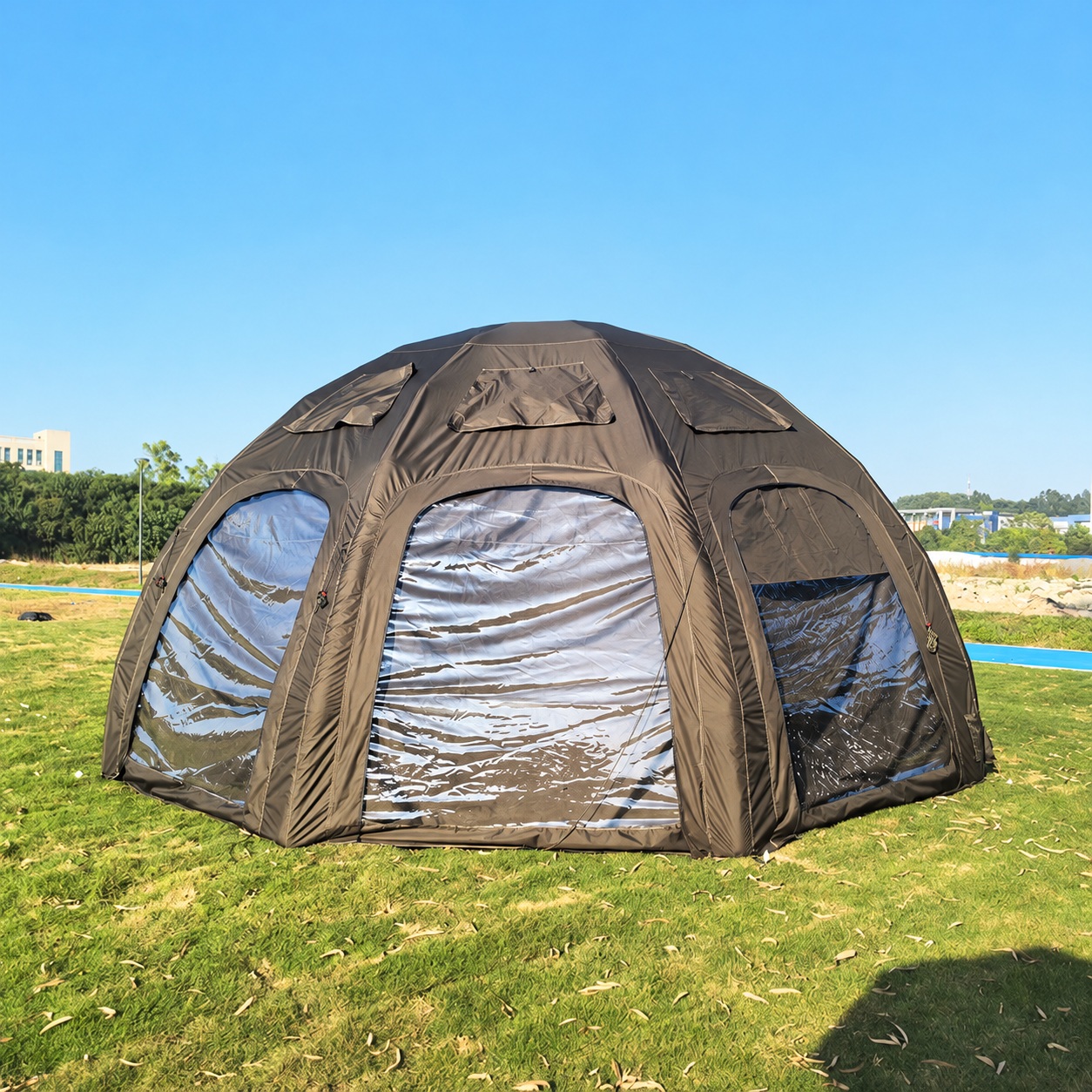 Dark olive domed airbeam tent with large clear reflective window panels and upper flaps.