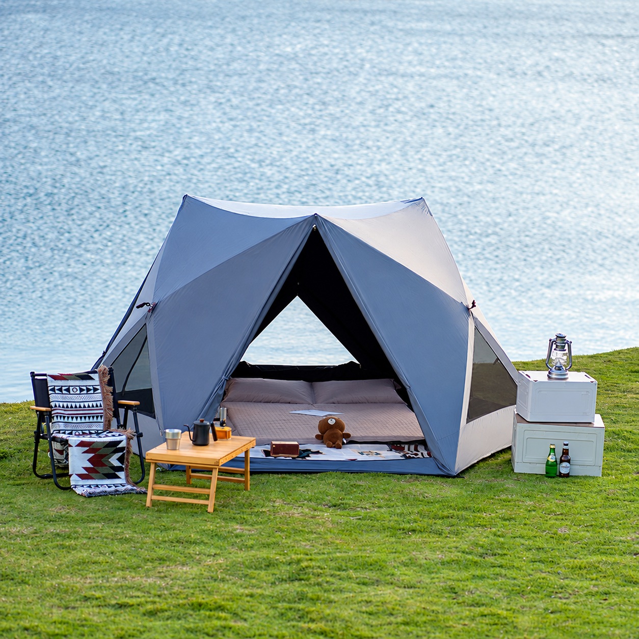 Metallic-gray quick-opening tent with a triangular front entrance and light roof panels