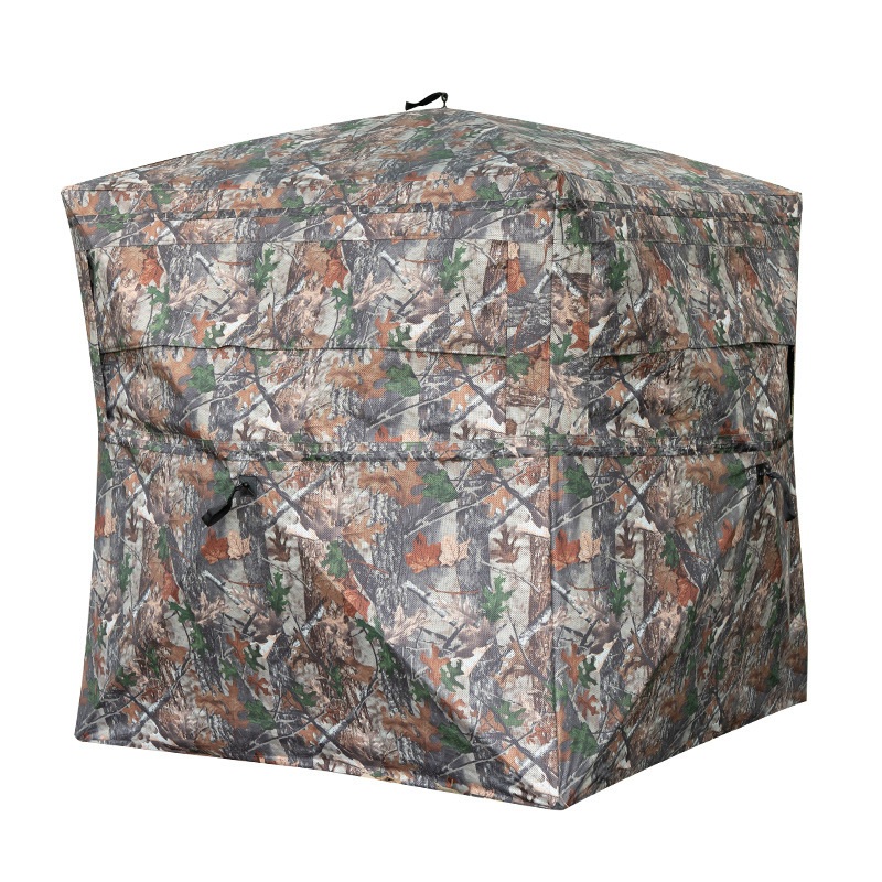 Camouflage box blind with a peaked roof, long horizontal window seams and black hub pull tabs.