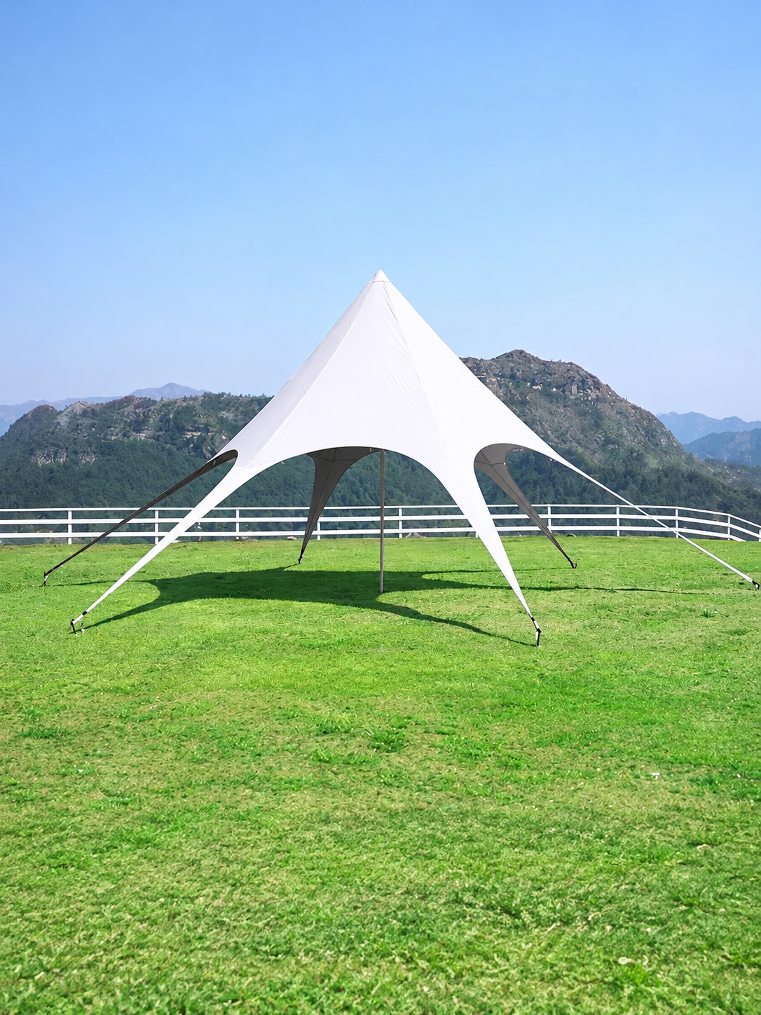 White single-peak star canopy with a central pole, six radial fabric legs and a dark underside.