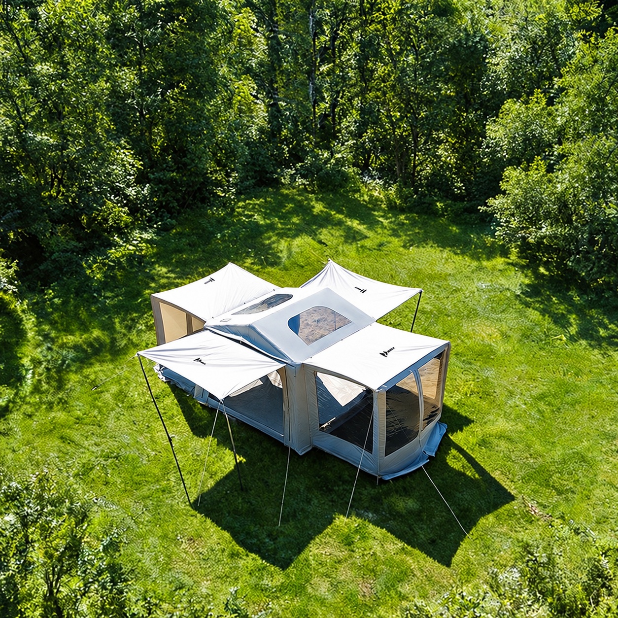 Aerial view of a light-colored gable air tent with raised awnings, roof windows and expanded mesh side bays