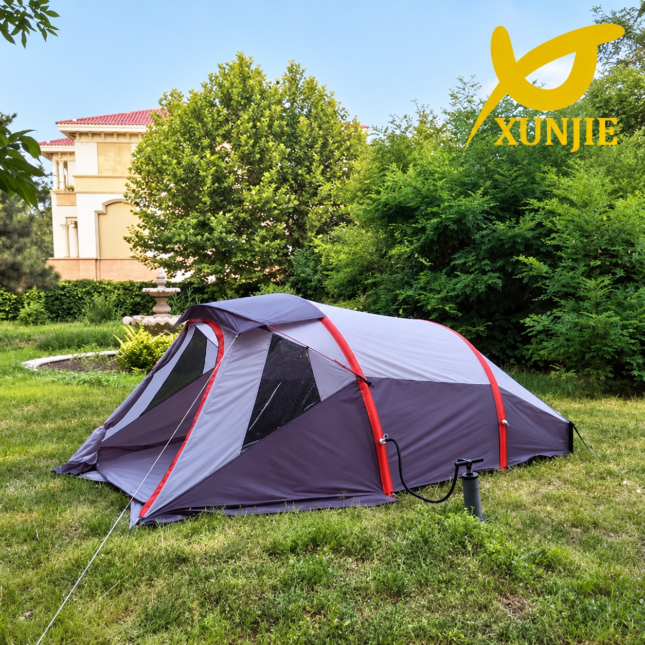 Grey tunnel-style camping tent with red airframe bands, a front vestibule and a pump beside it.