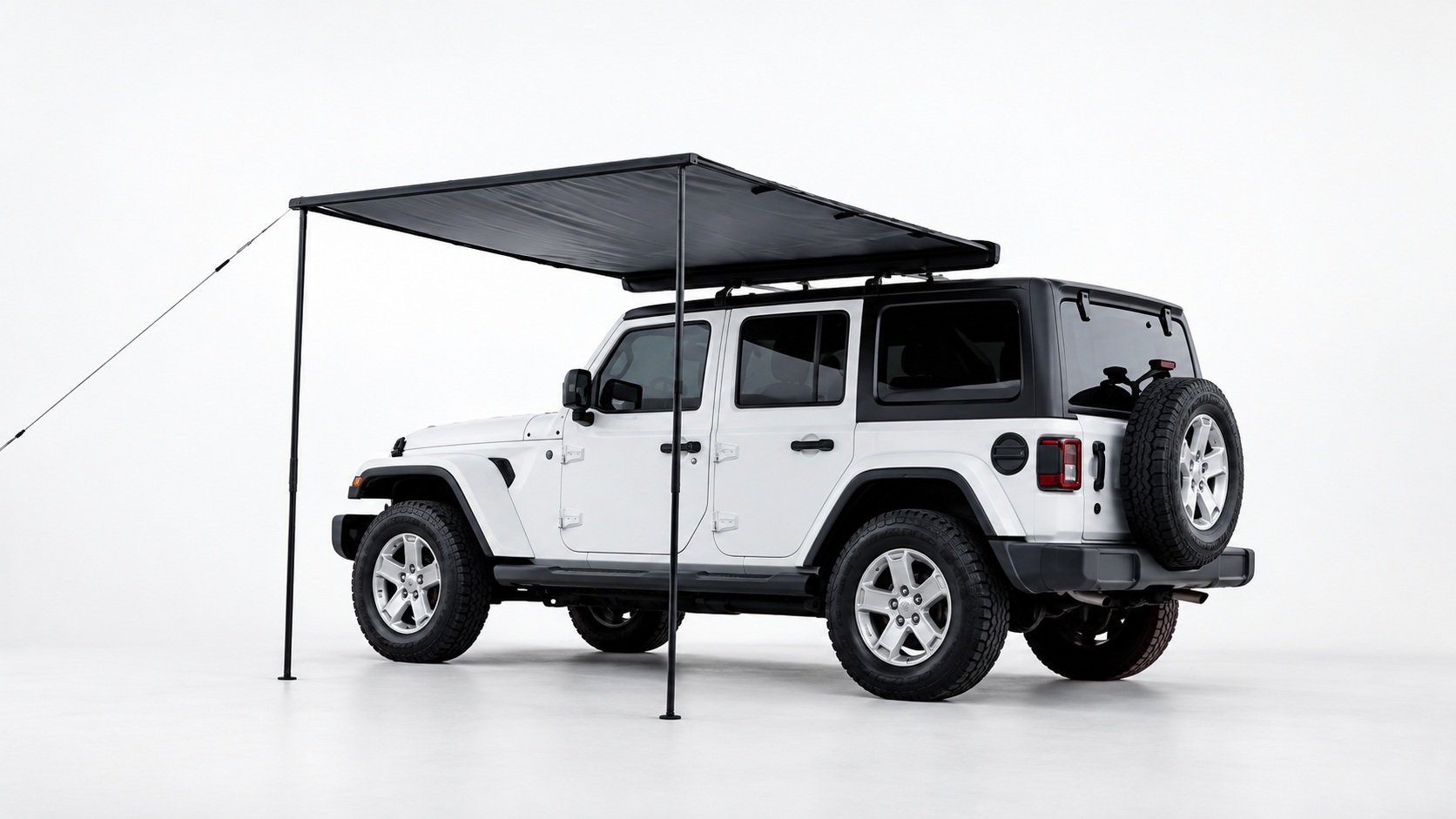 Dark rectangular side canopy mounted to a white SUV