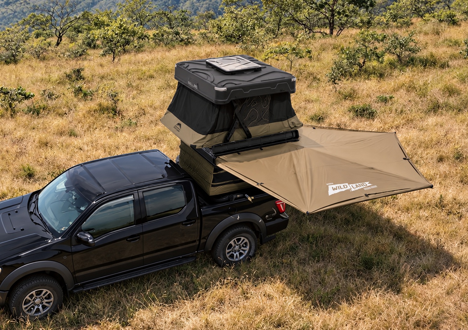 Compact hardshell awning opened beside a pickup with a separate rooftop tent above